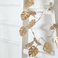 Metallic gold artificial monstera leaf hanging vine plant garland.