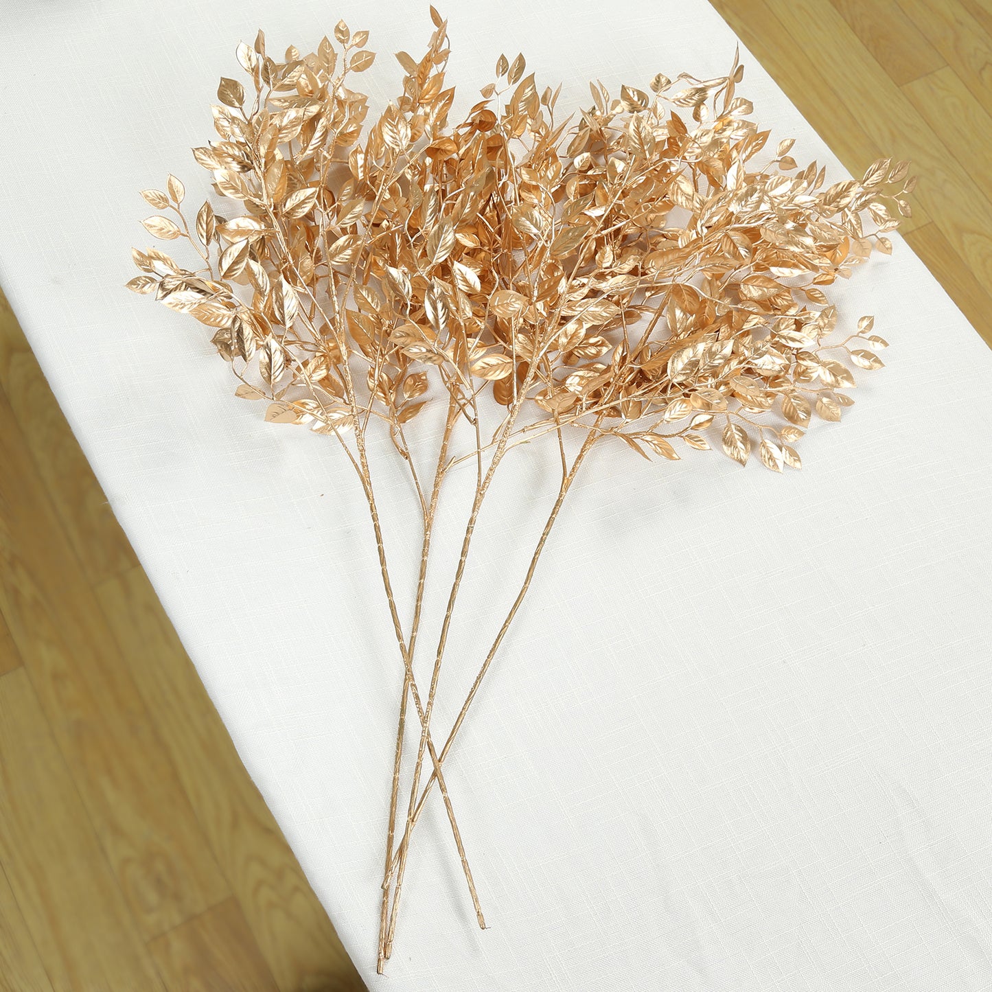 Gold metallic artificial leaf spray for decorative arrangements.