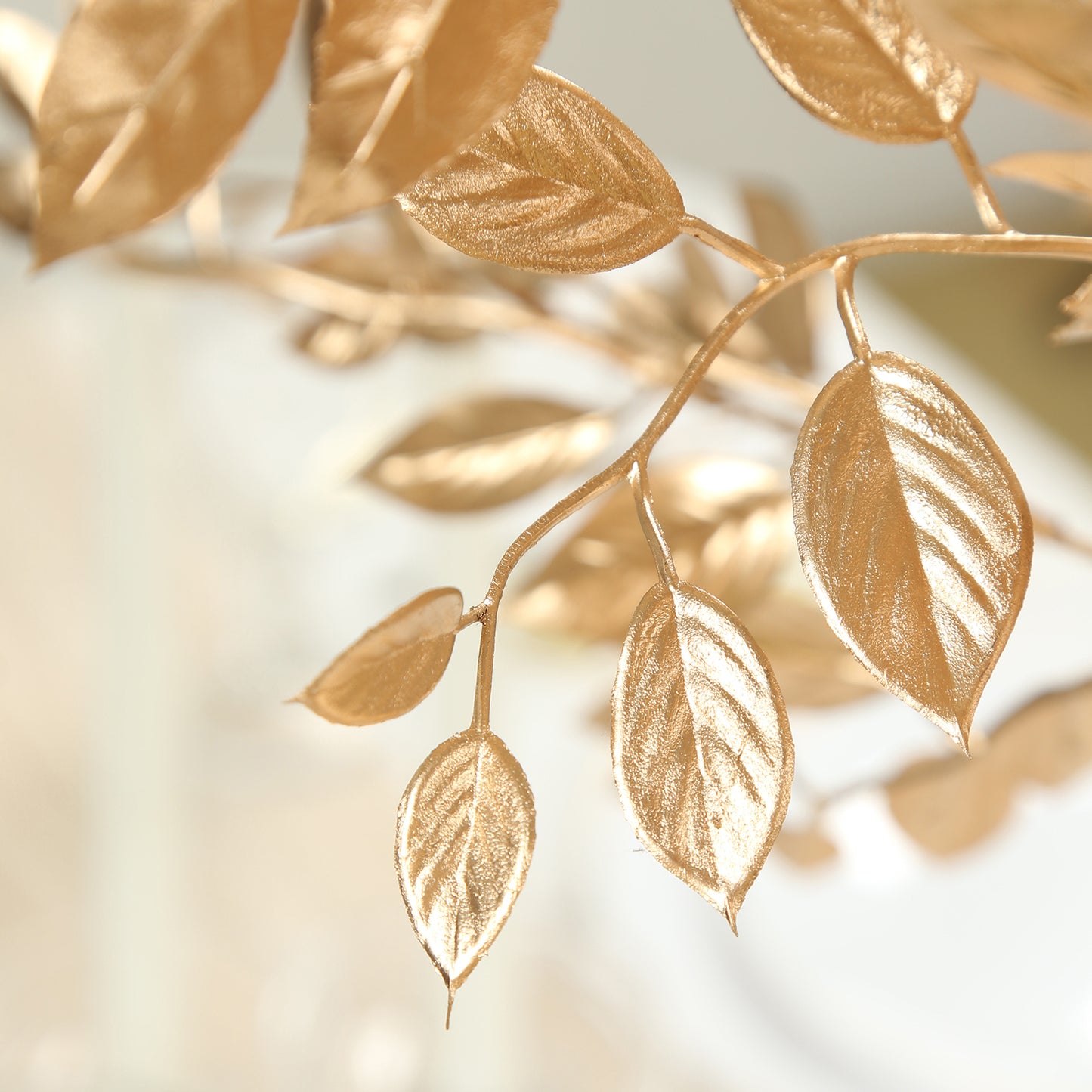 Gold metallic artificial leaf spray for decorative arrangements.