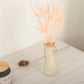 Blush rabbit tail dried pampas grass flower bouquet in a clear vase.