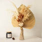 Brown pampas grass flower bouquet in a glass vase.
