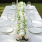 Cream ivory silk rose flower table runner with greenery centerpiece.