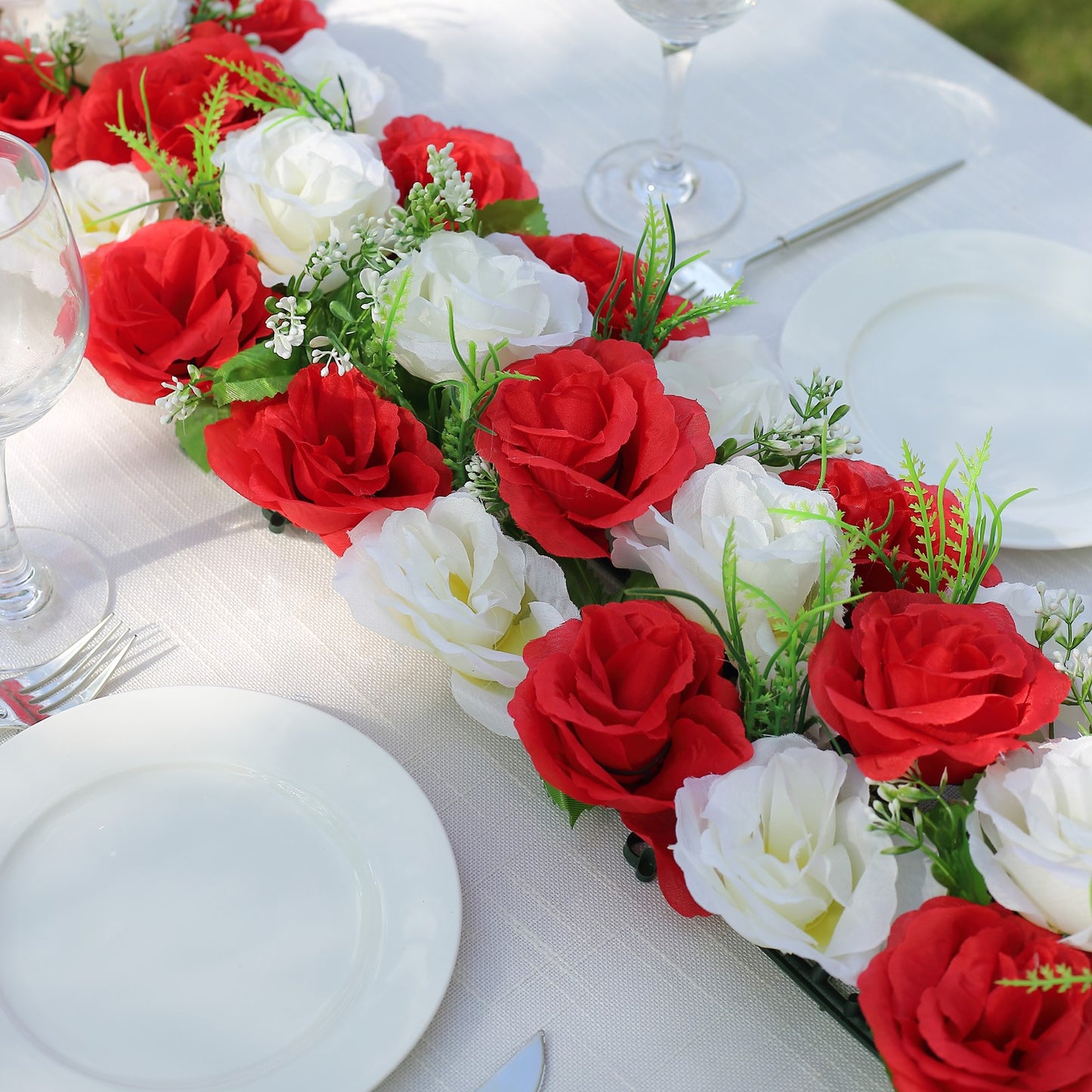 Red and white artificial silk rose flower table runner centerpiece.