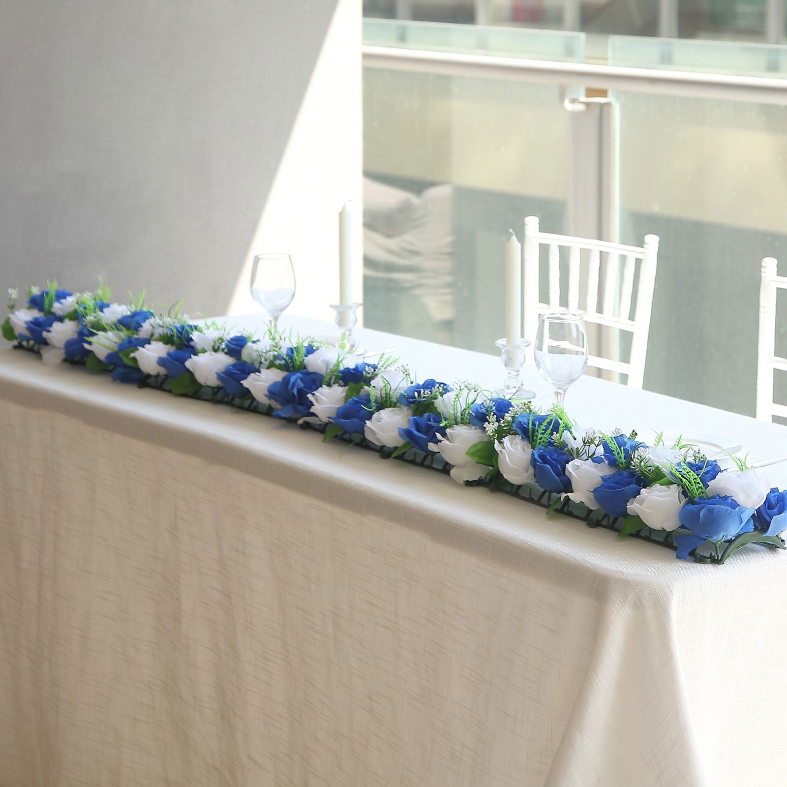 White and royal blue silk rose flower table runner centerpiece.