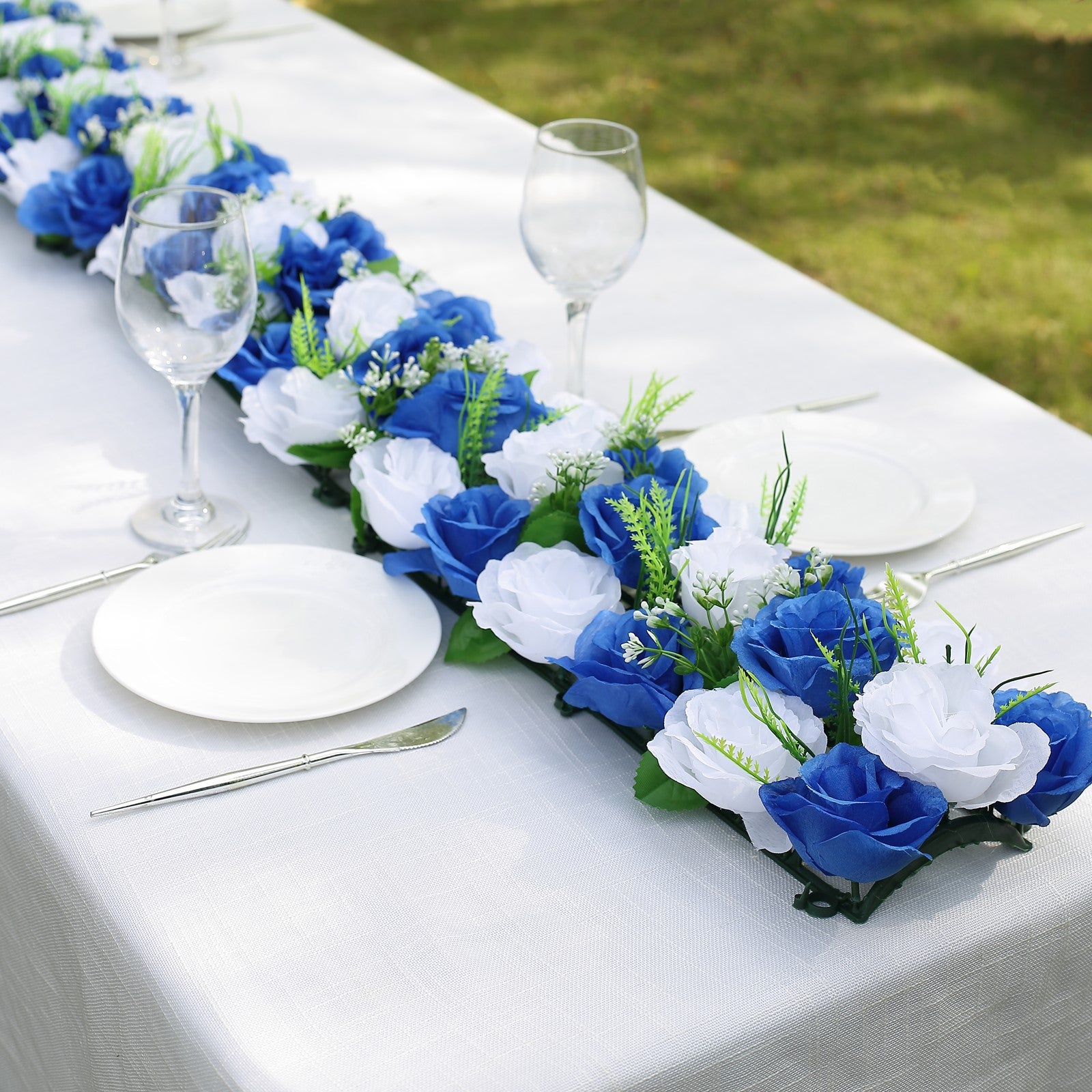 White and royal blue silk rose flower table runner centerpiece.