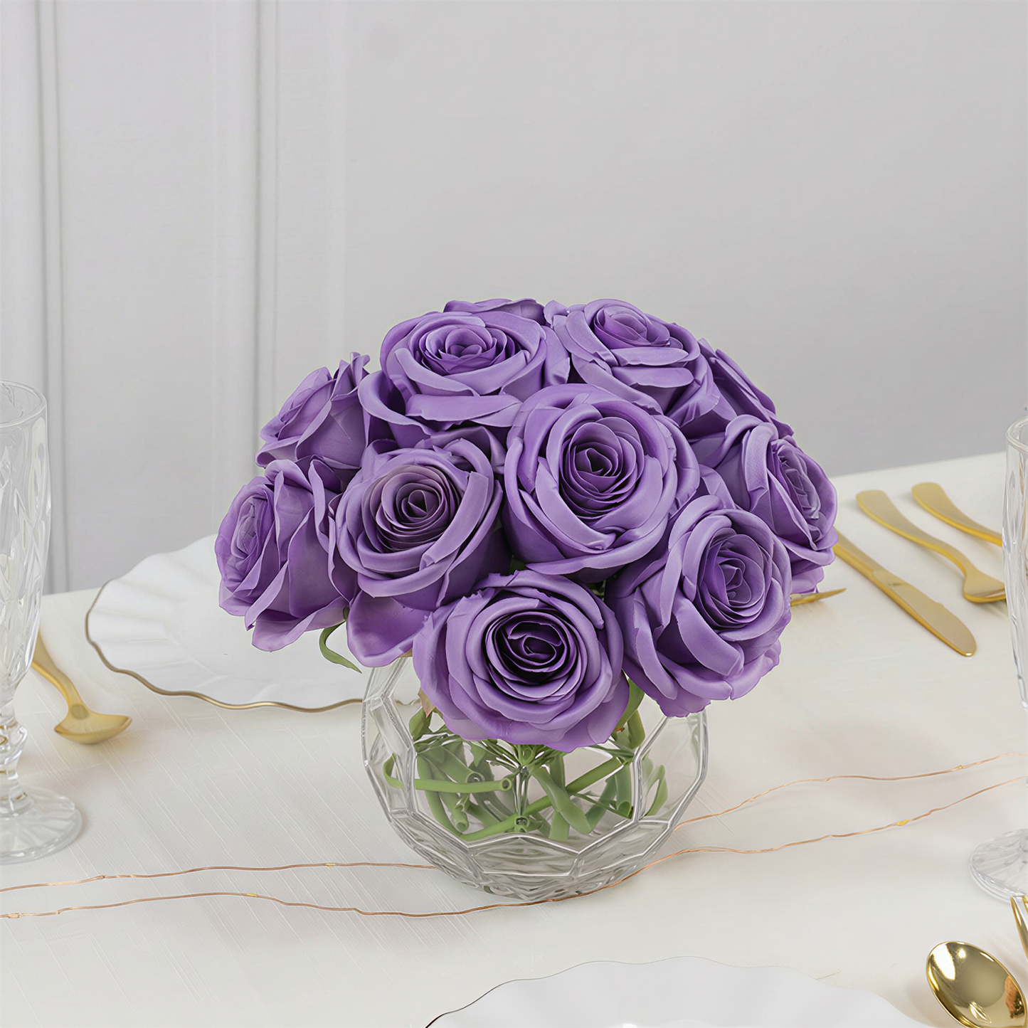 Purple artificial silk roses in a bouquet arrangement.