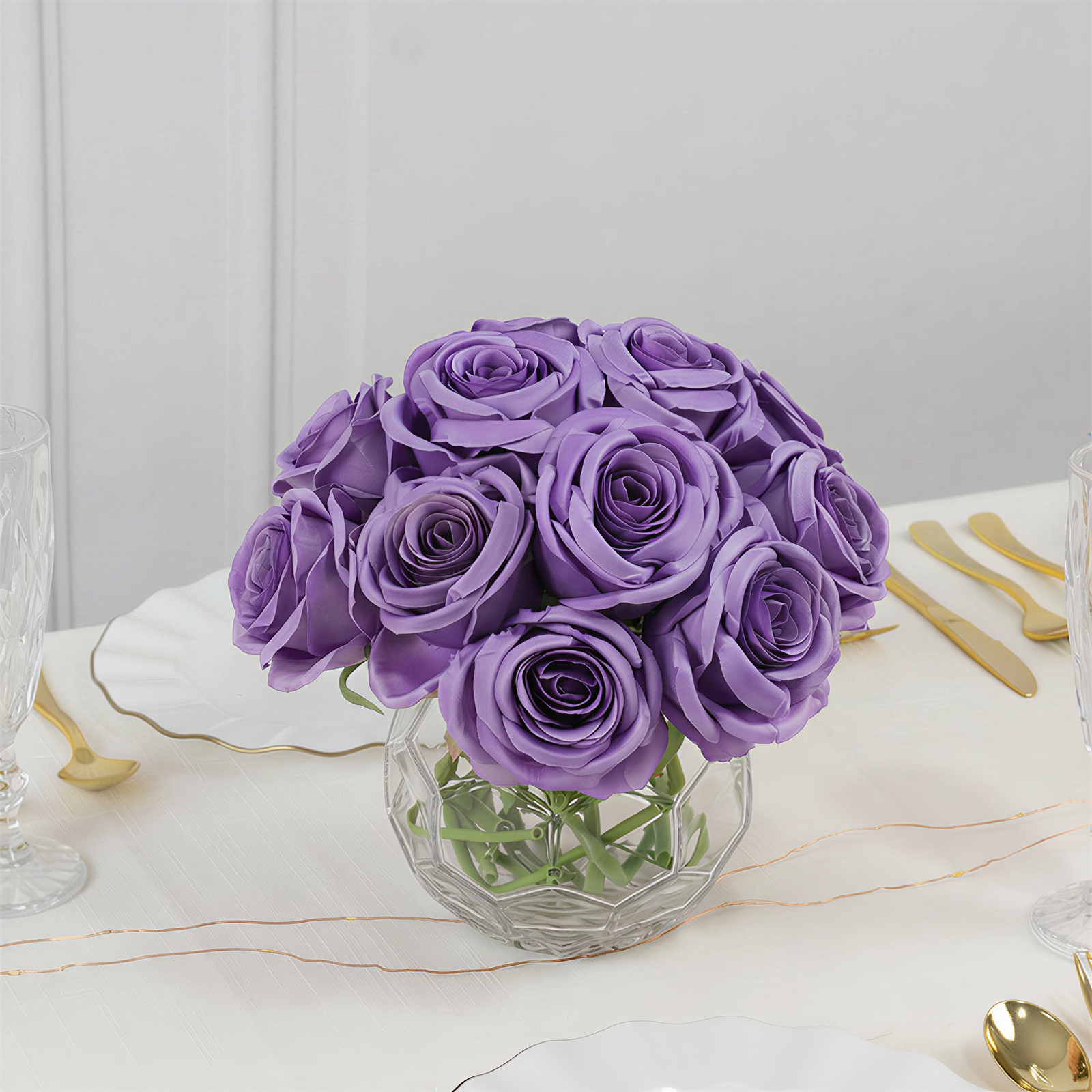 Purple artificial silk roses in a bouquet arrangement.