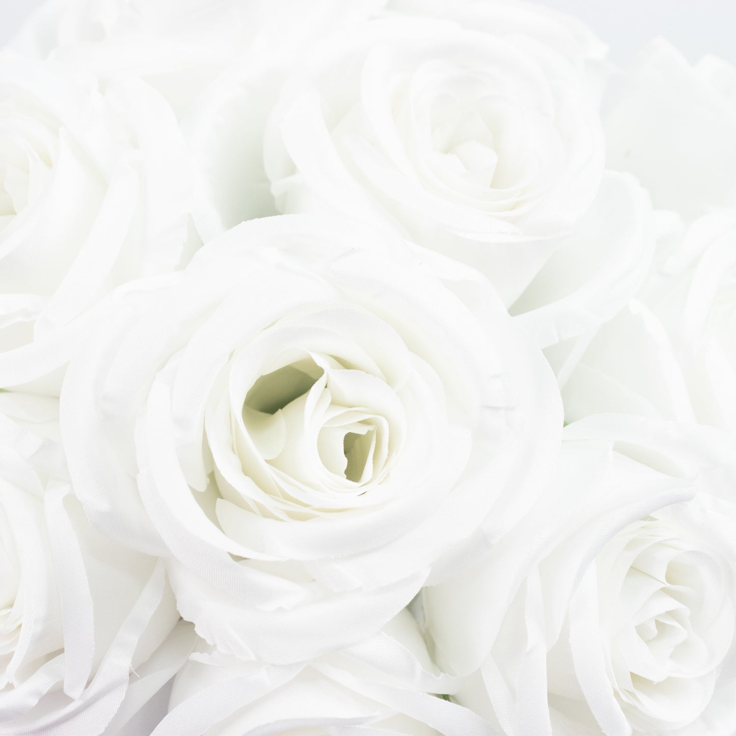 White artificial silk roses for flower bouquet arrangements.