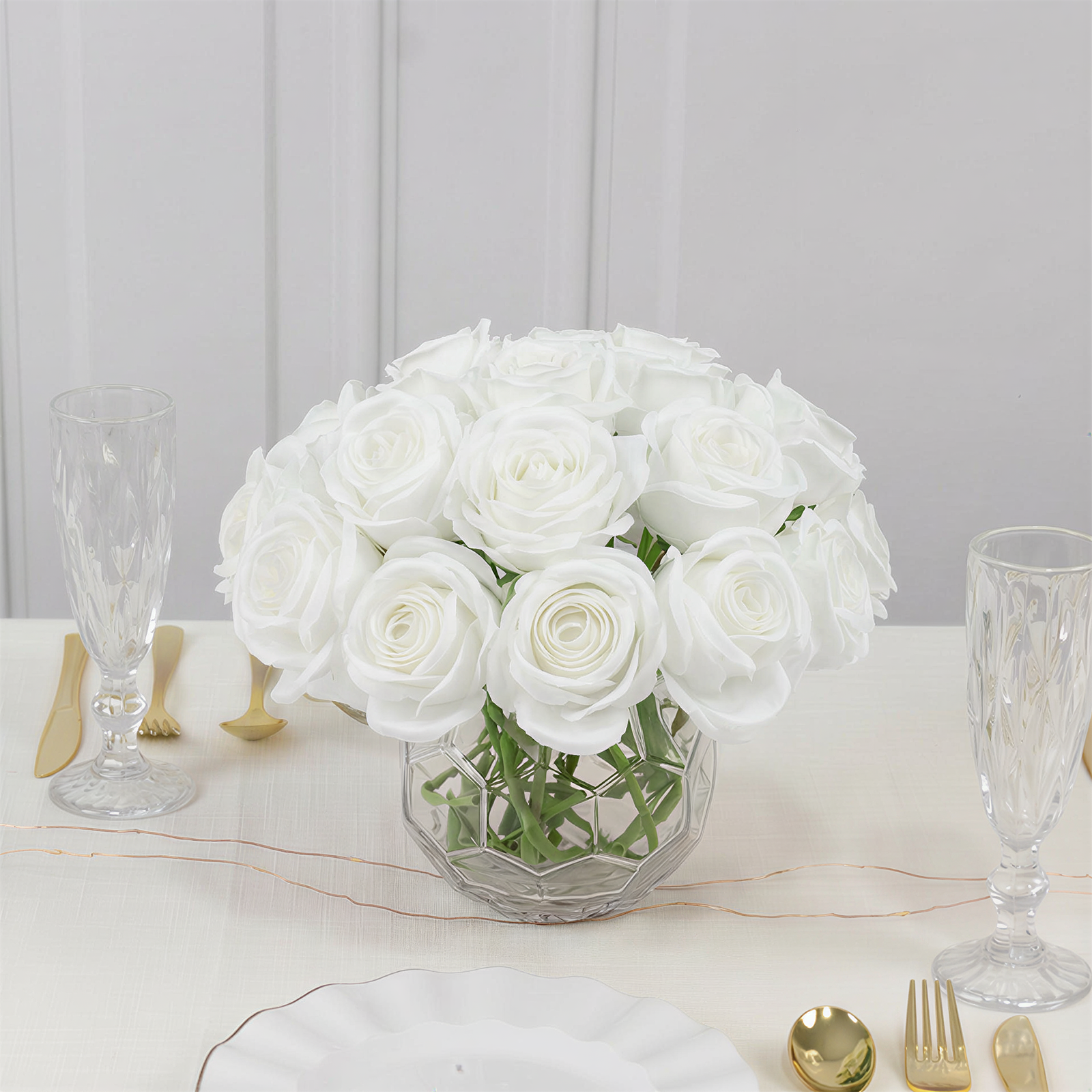 White artificial silk roses in a bouquet arrangement.