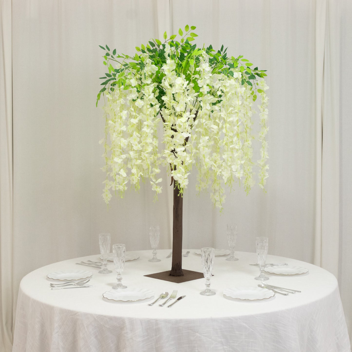 Cream artificial wisteria tree with cascading silk flowers for event centerpieces.