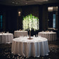 Cream artificial wisteria tree centerpiece with cascading silk flowers.