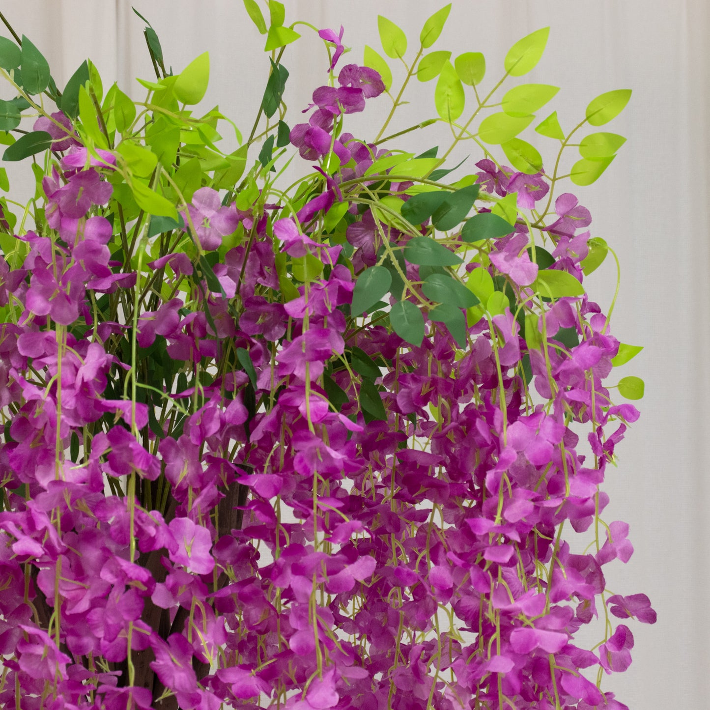Lavender lilac artificial wisteria tree with cascading silk flowers.