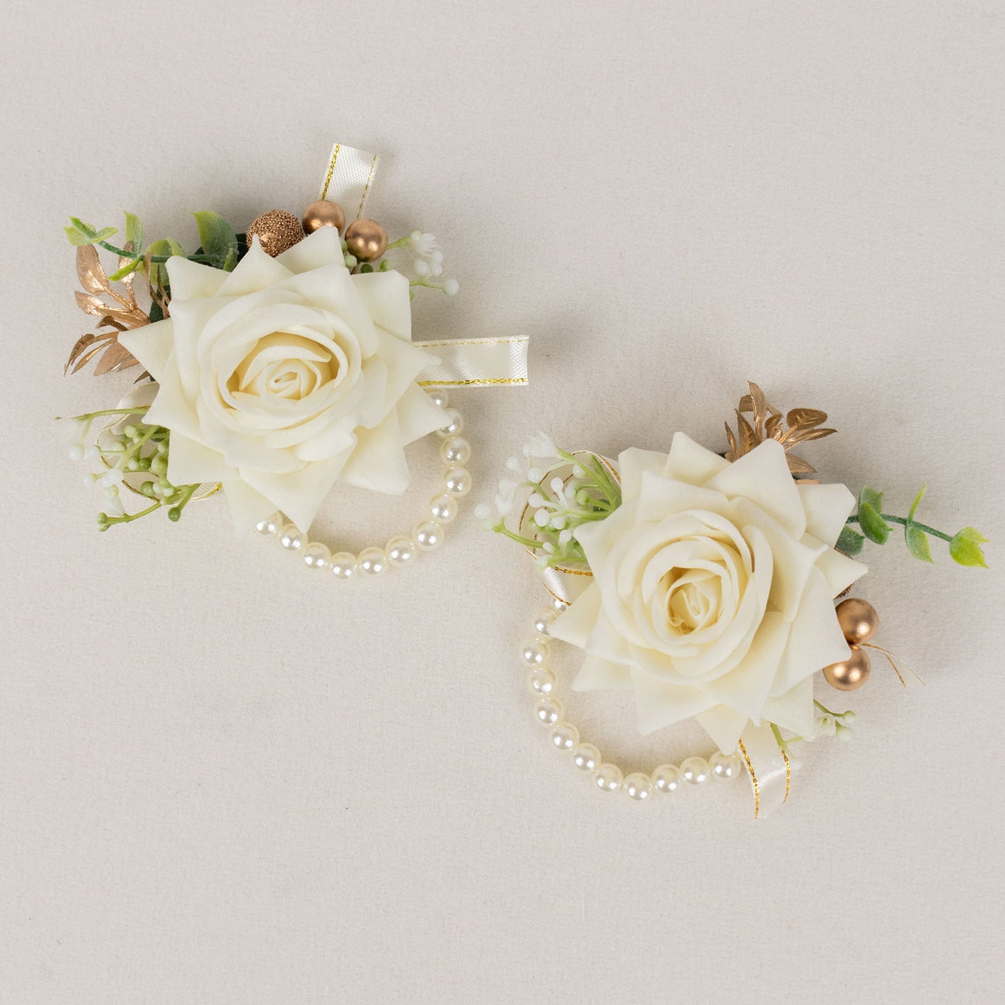 White artificial rose wrist corsages with pearls for weddings.