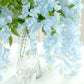 Light blue silk wisteria flower garland vines in a clear vase.