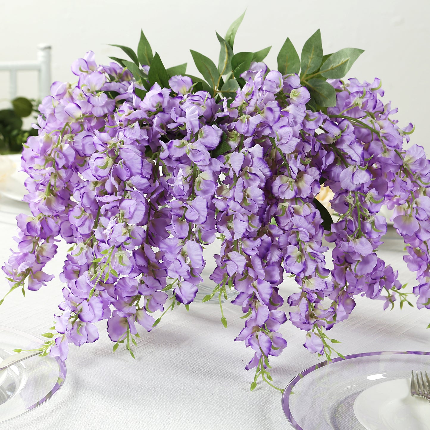 Purple silk wisteria vines hanging plants in a decorative arrangement.
