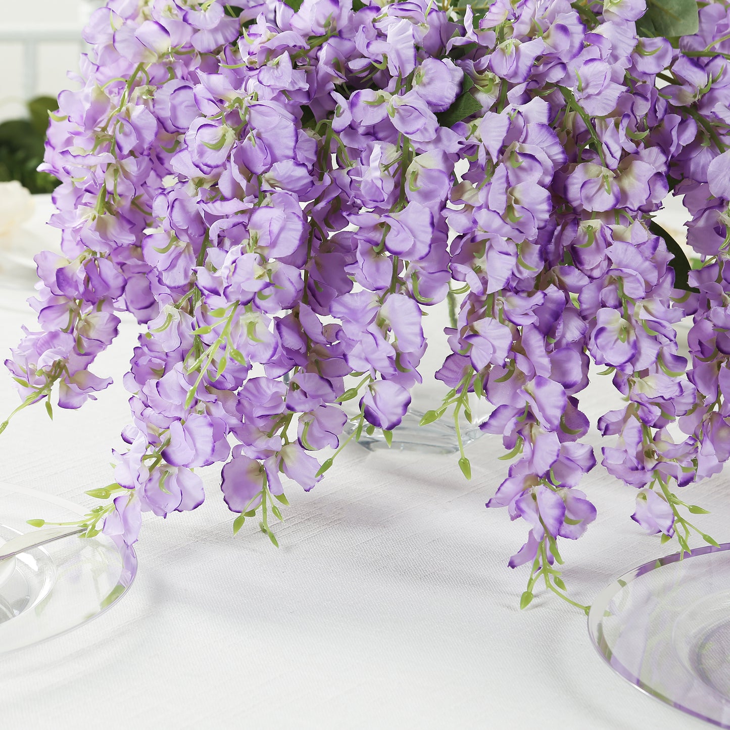 Purple silk wisteria vines hanging plants in a decorative arrangement.