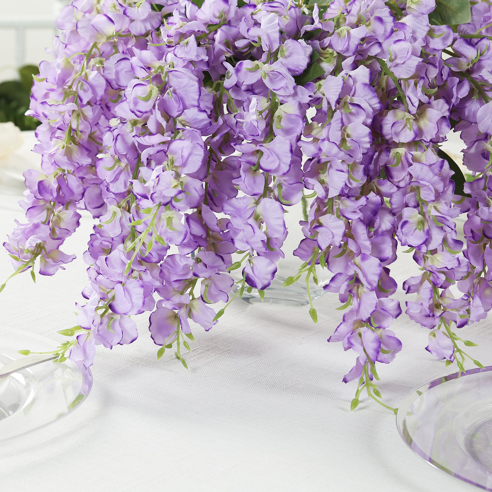 Purple silk wisteria vines hanging plants in a decorative arrangement.