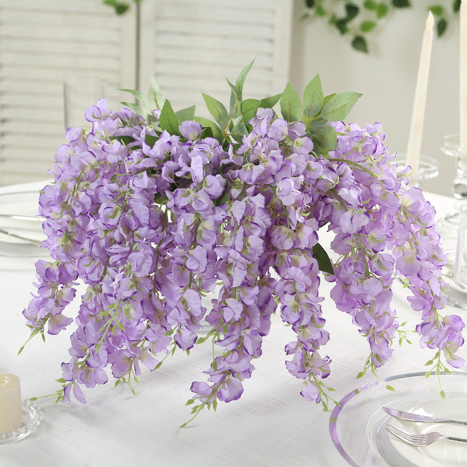 Purple silk wisteria vines hanging plants in a decorative arrangement.
