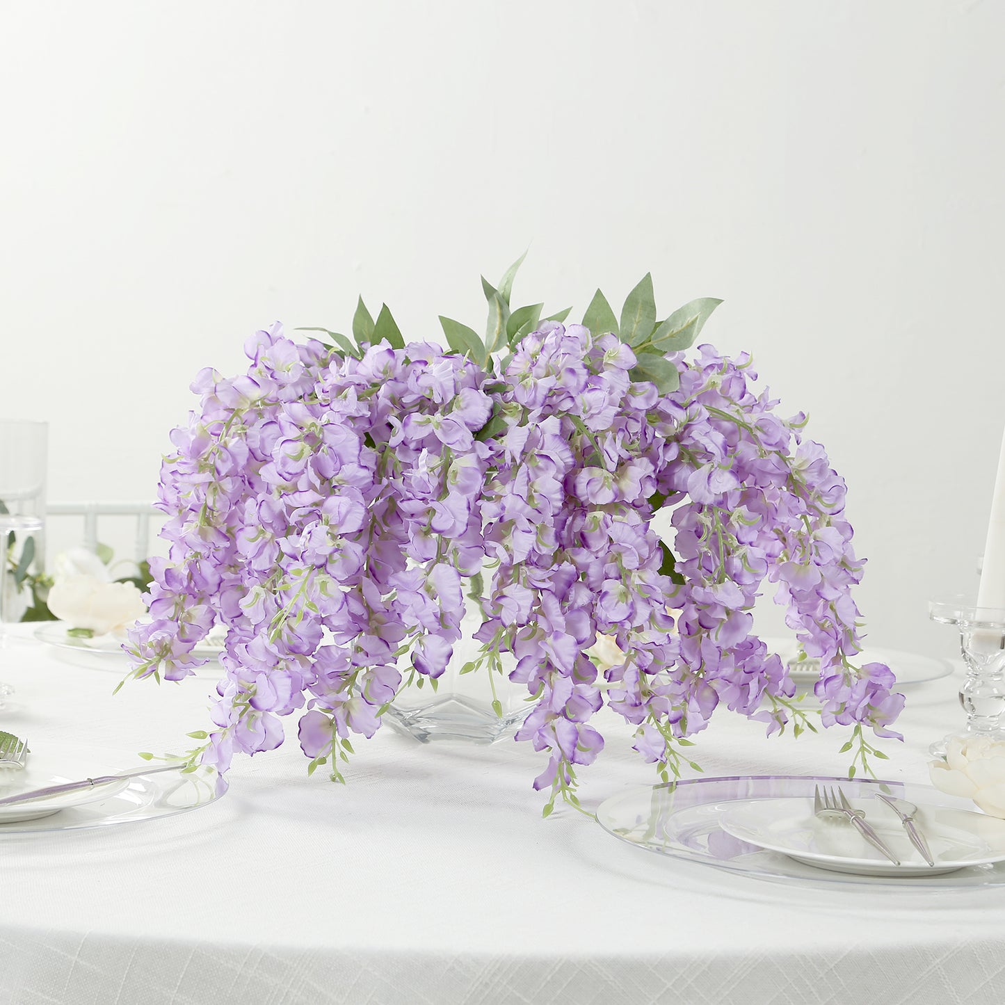 Purple silk wisteria vines hanging plants in a decorative arrangement.