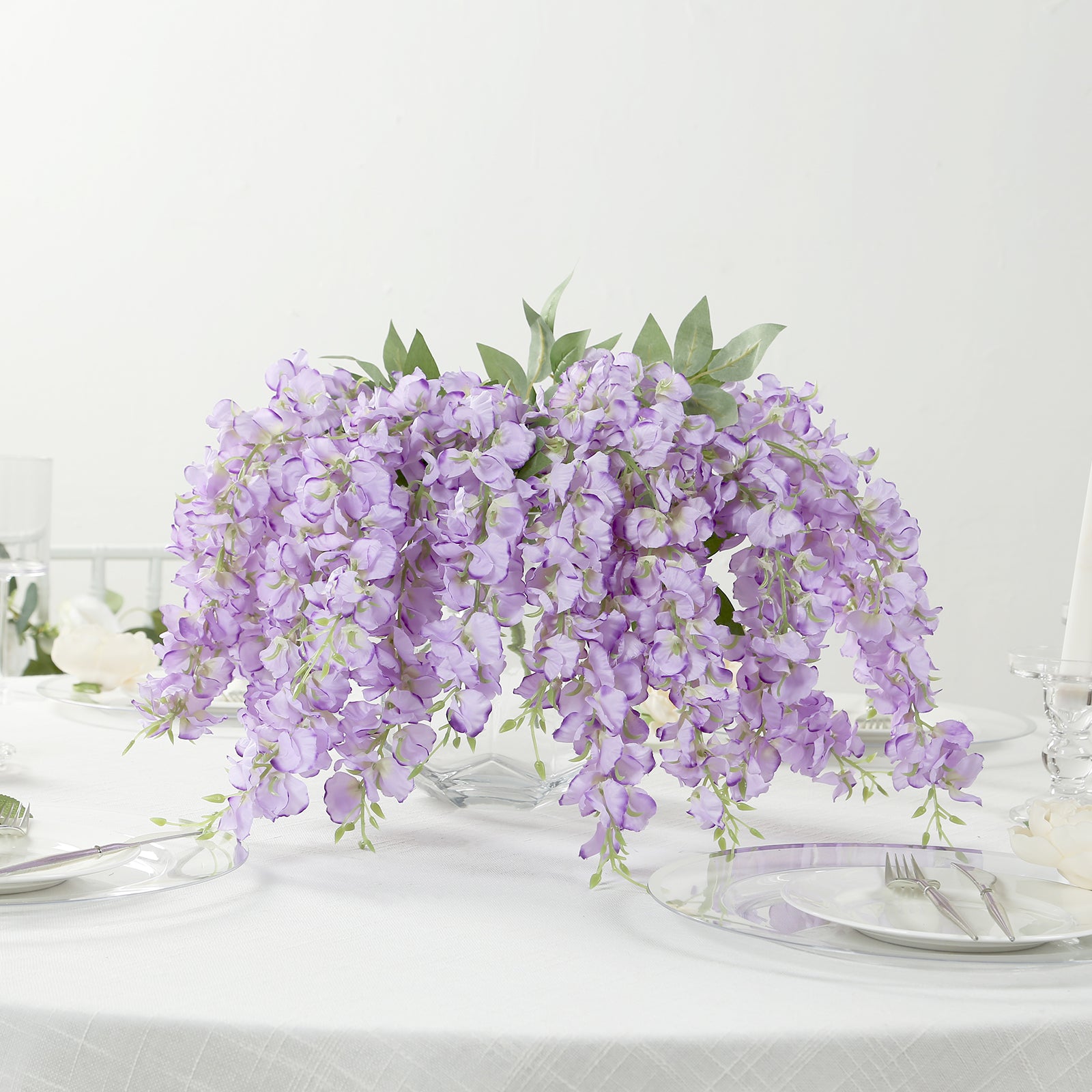 Purple silk wisteria vines hanging plants in a decorative arrangement.