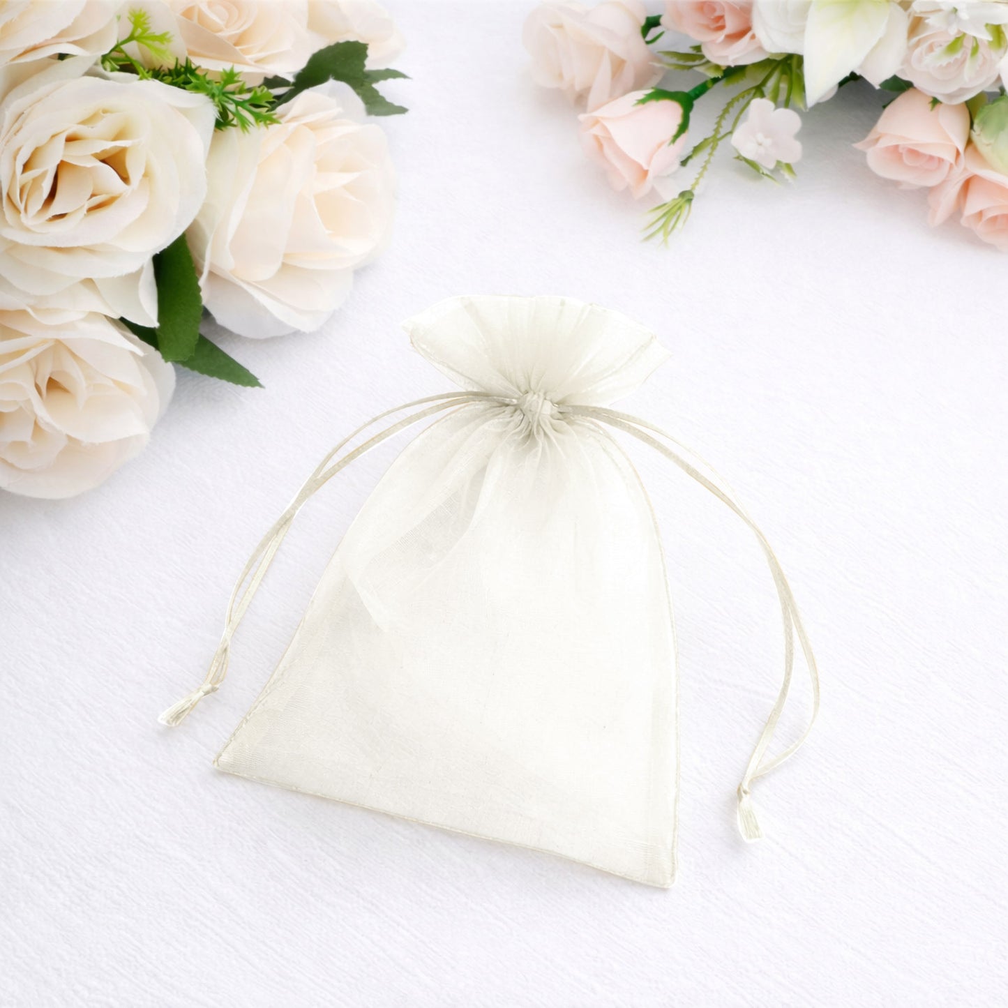 Ivory organza gift bag with drawstring, perfect for wedding favors.