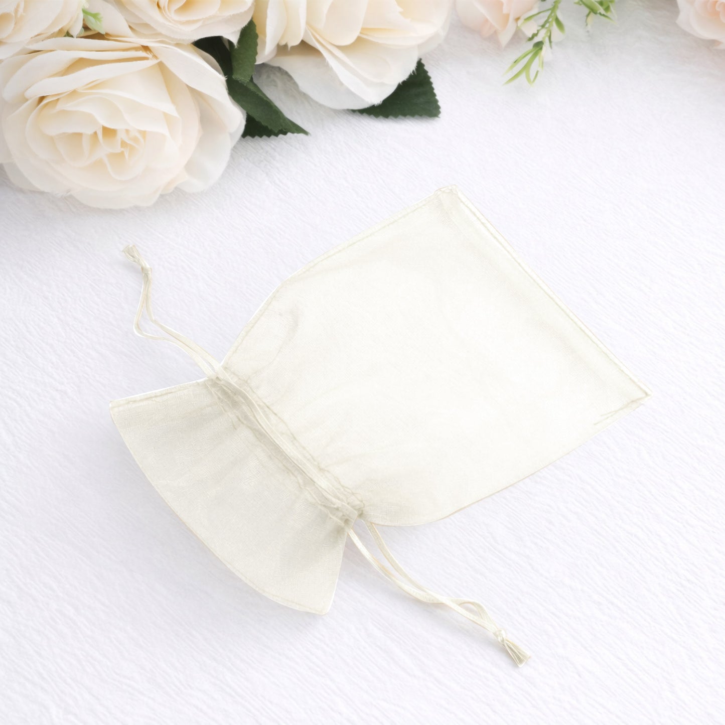 Ivory organza gift bag with drawstring, 4" x 6", perfect for wedding favors.