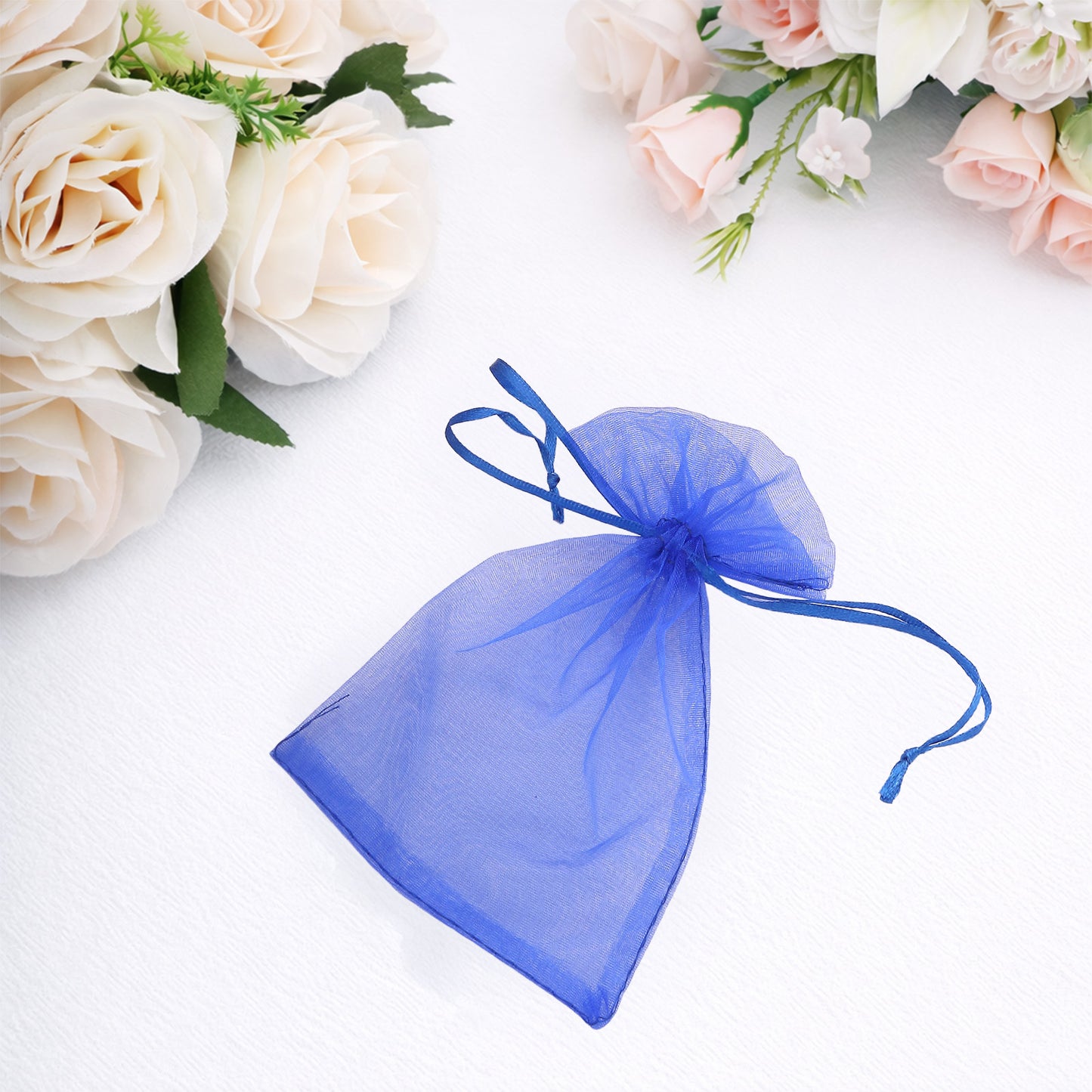 Royal blue organza gift bag with drawstring, perfect for wedding favors.