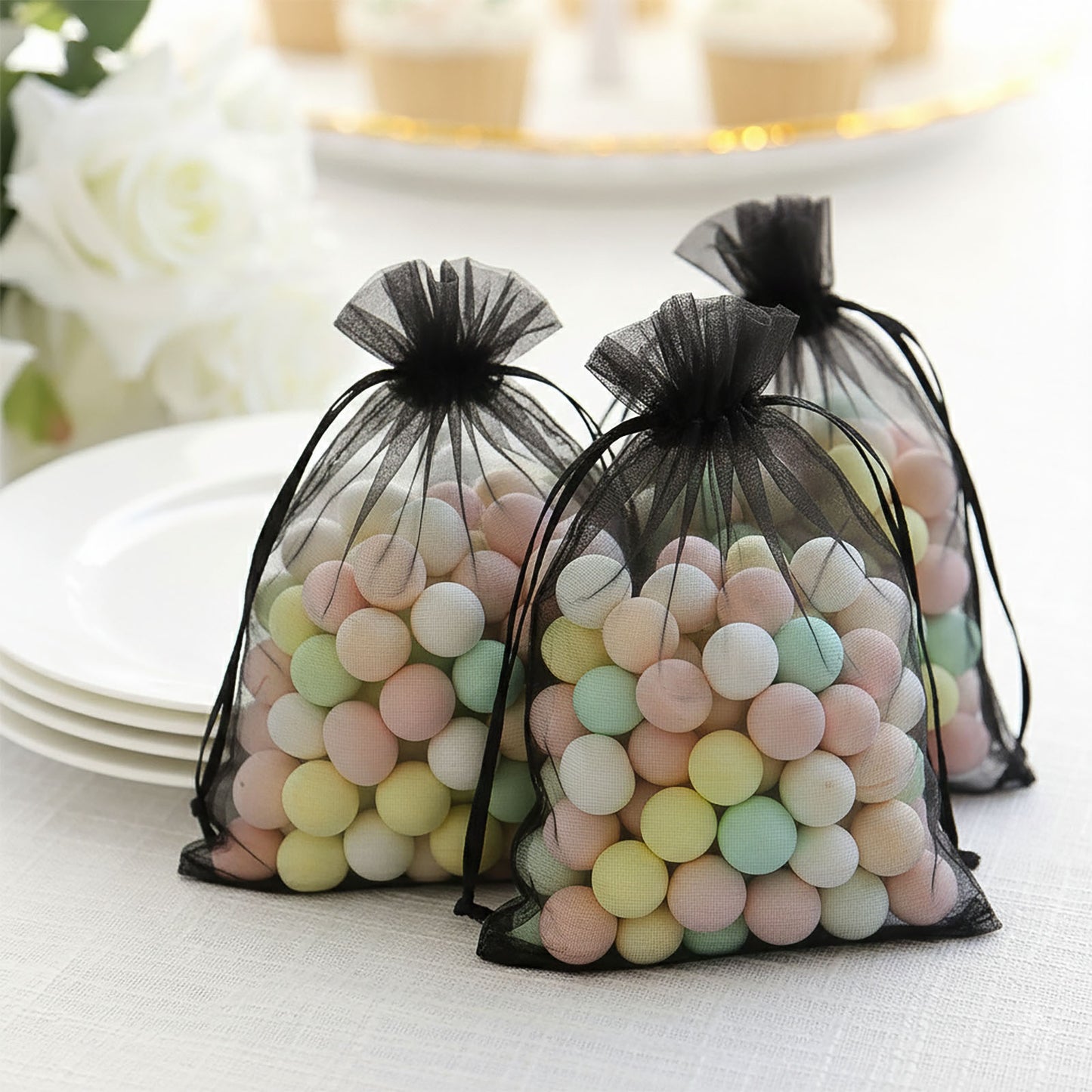 Black organza gift bags with drawstring, perfect for wedding favors.