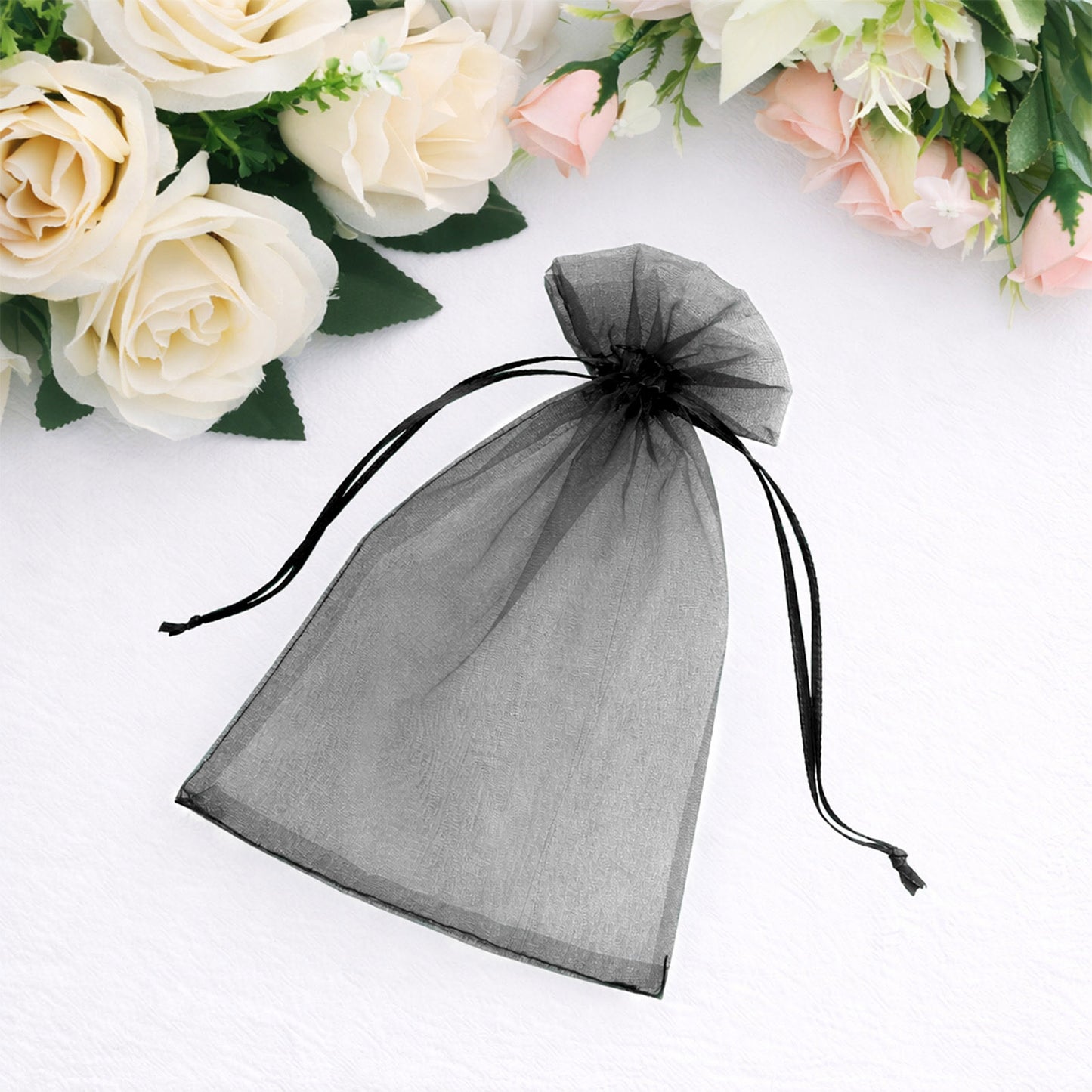 Black organza gift bag with drawstring, 5" x 7", ideal for wedding favors.
