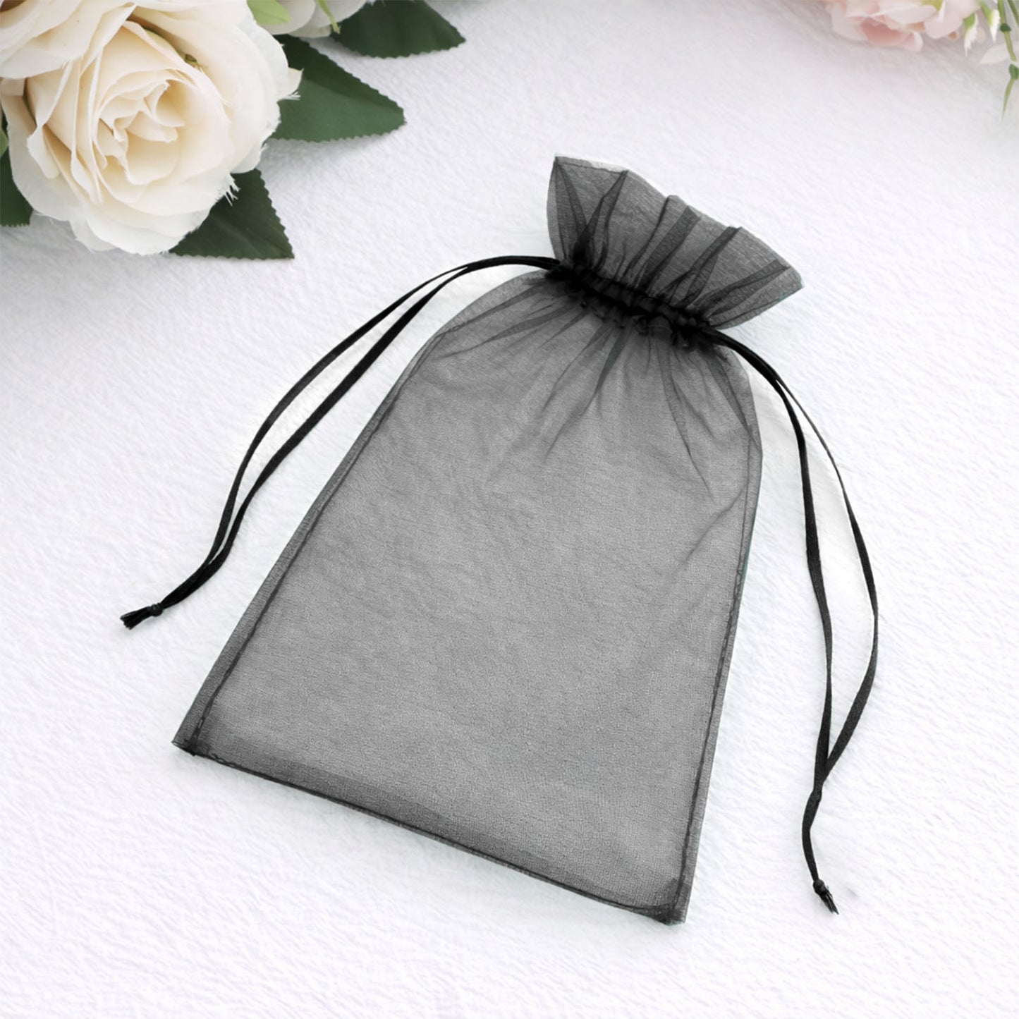 Black organza gift bag with drawstring, 5" x 7", perfect for weddings.