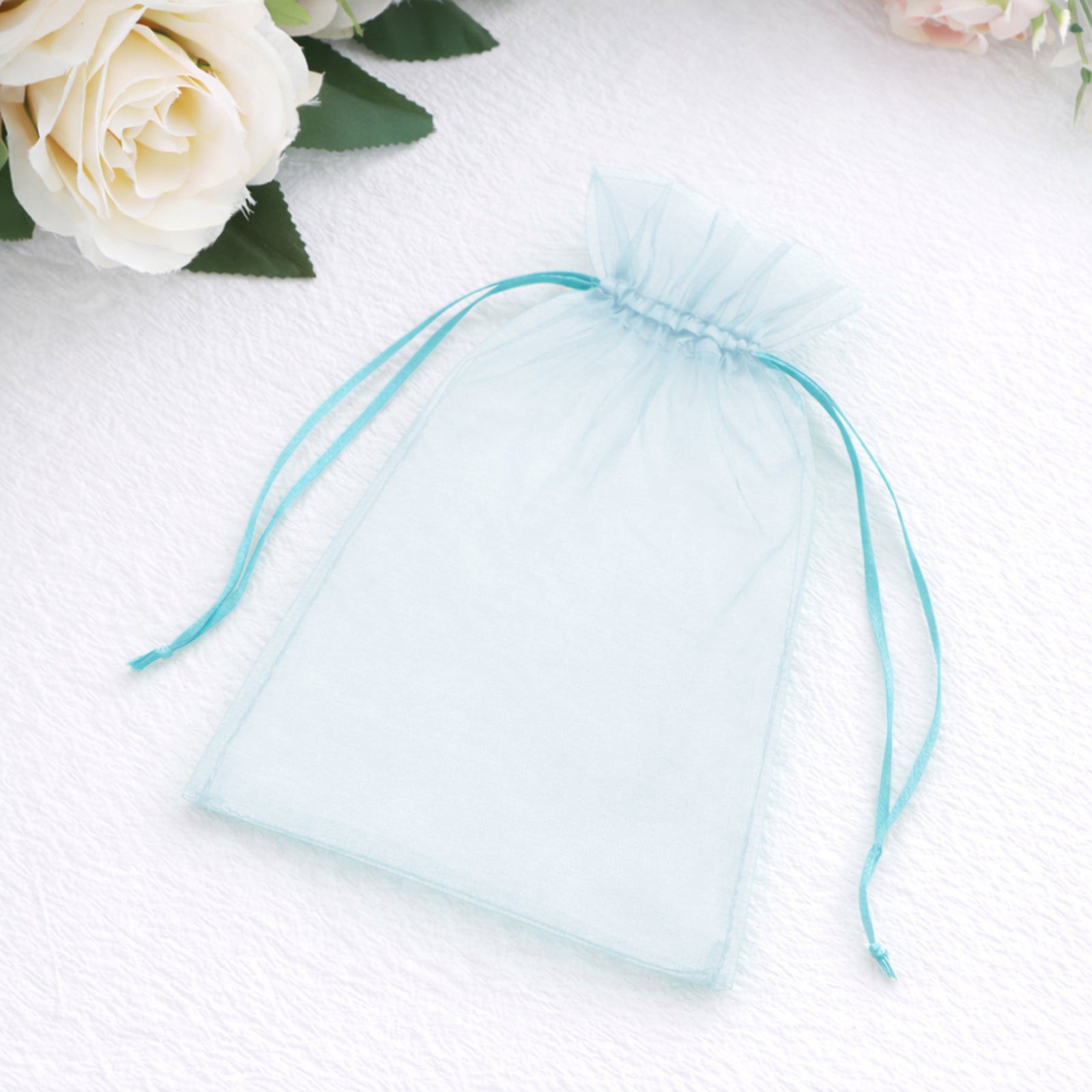 Light blue organza gift bag with drawstring, 5" x 7" for wedding favors.