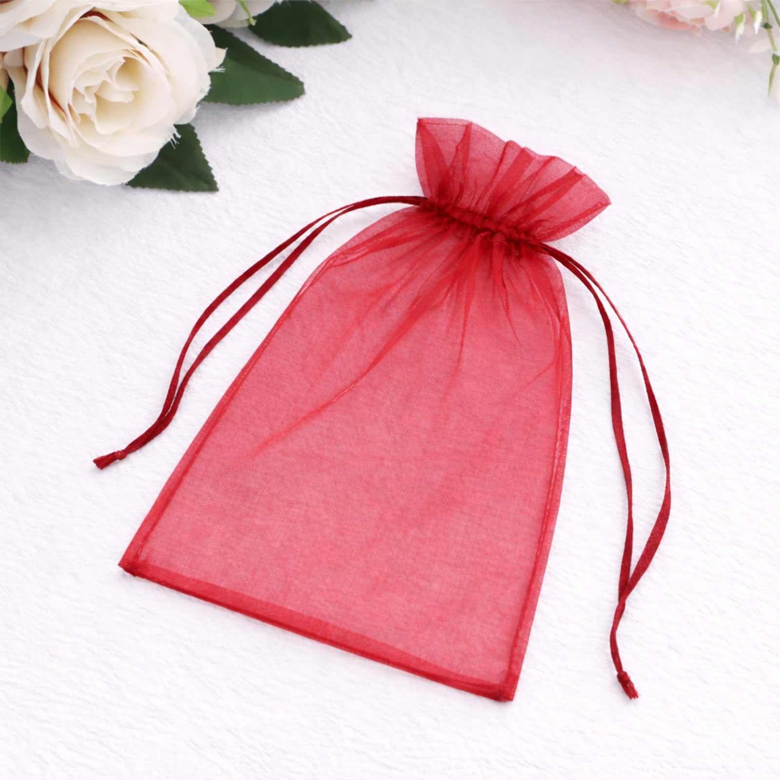 Burgundy organza gift bag with drawstring, perfect for wedding favors.