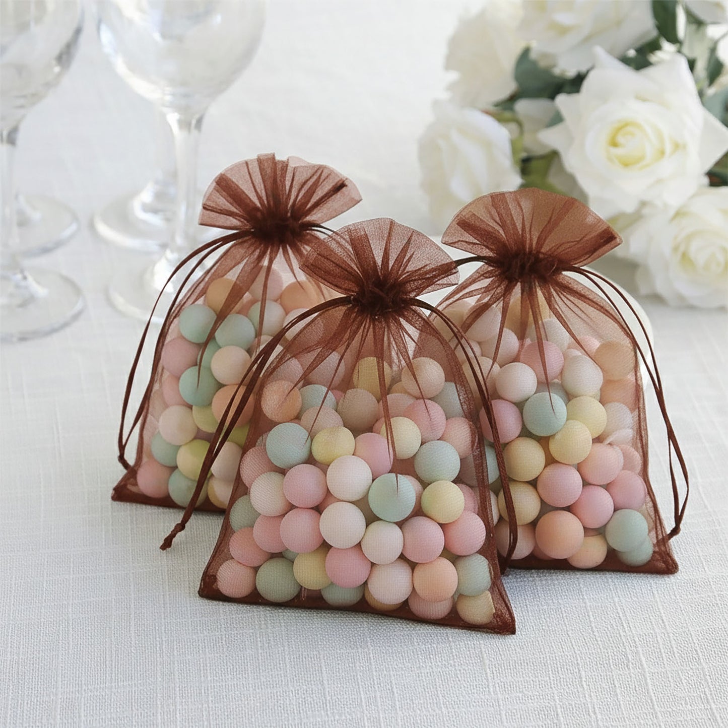 Chocolate organza gift bags filled with colorful candies.