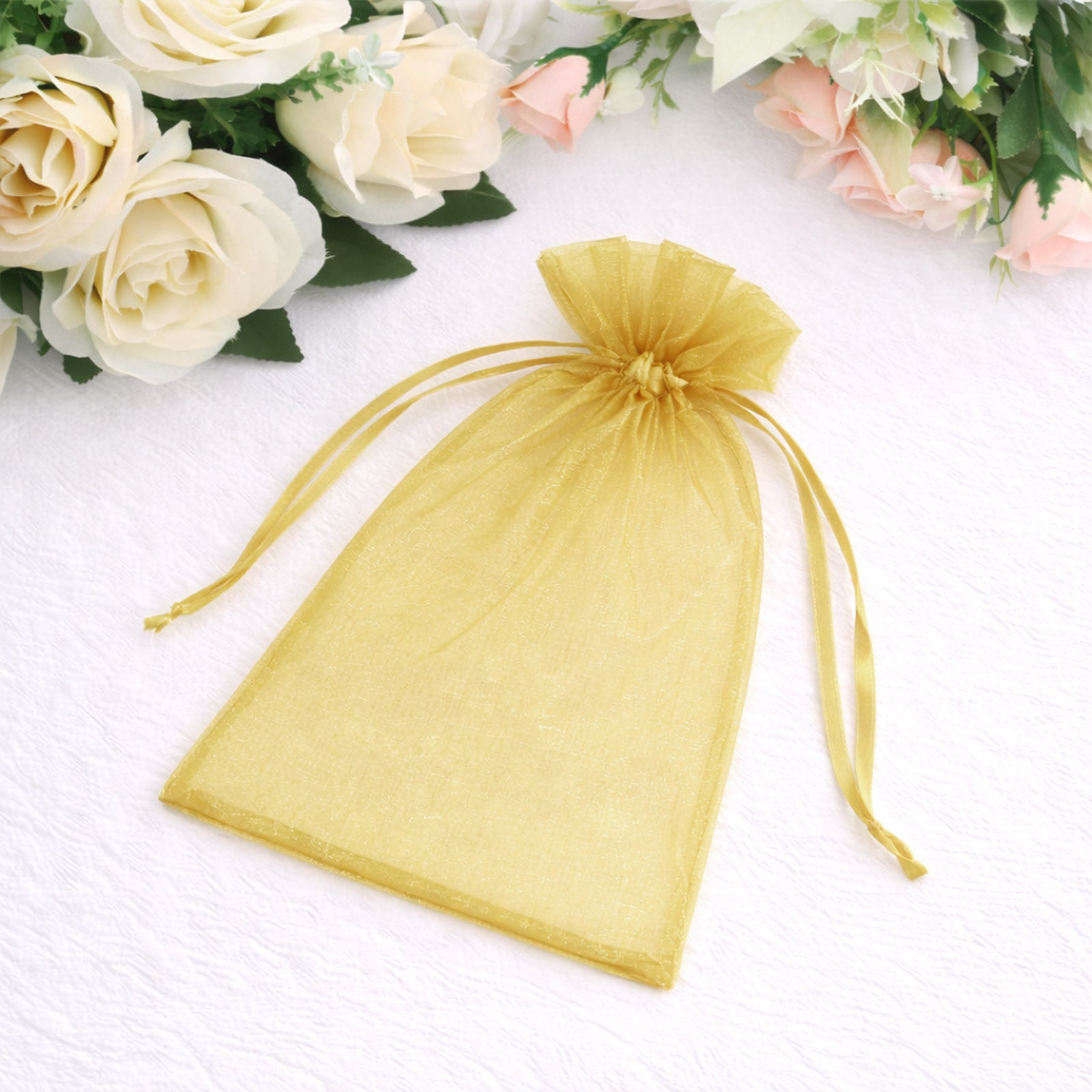 Gold organza gift bag with drawstring, perfect for wedding favors.