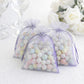 Lavender organza gift bags filled with pastel candies, perfect for party favors.