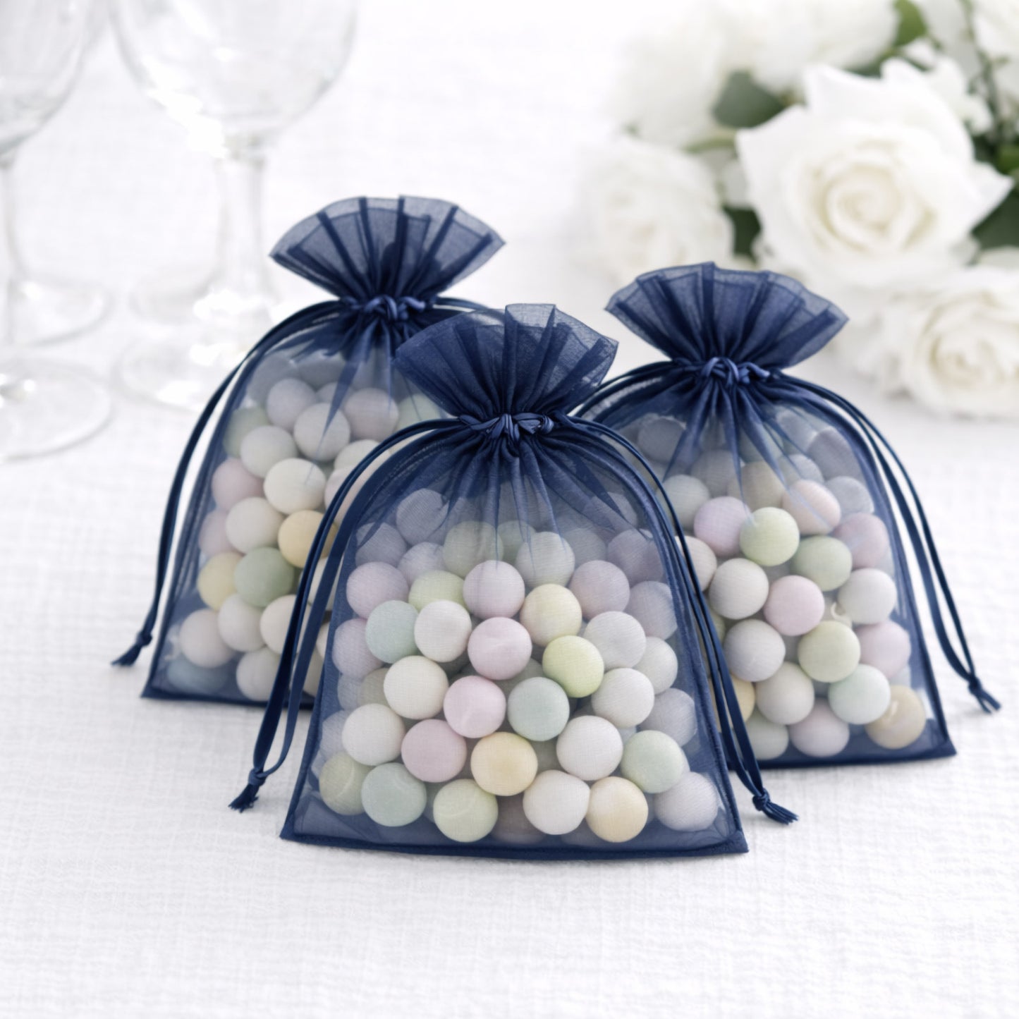 Navy blue organza gift bags with drawstring, perfect for wedding favors.