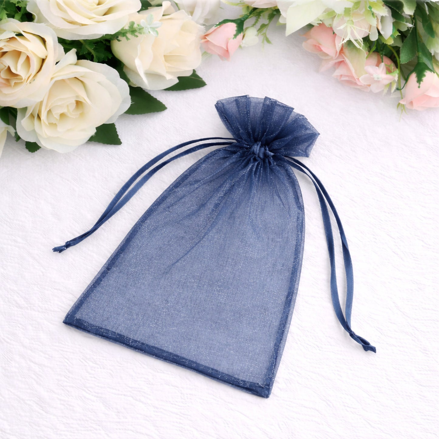 Navy blue organza gift bag with drawstring for wedding favors.