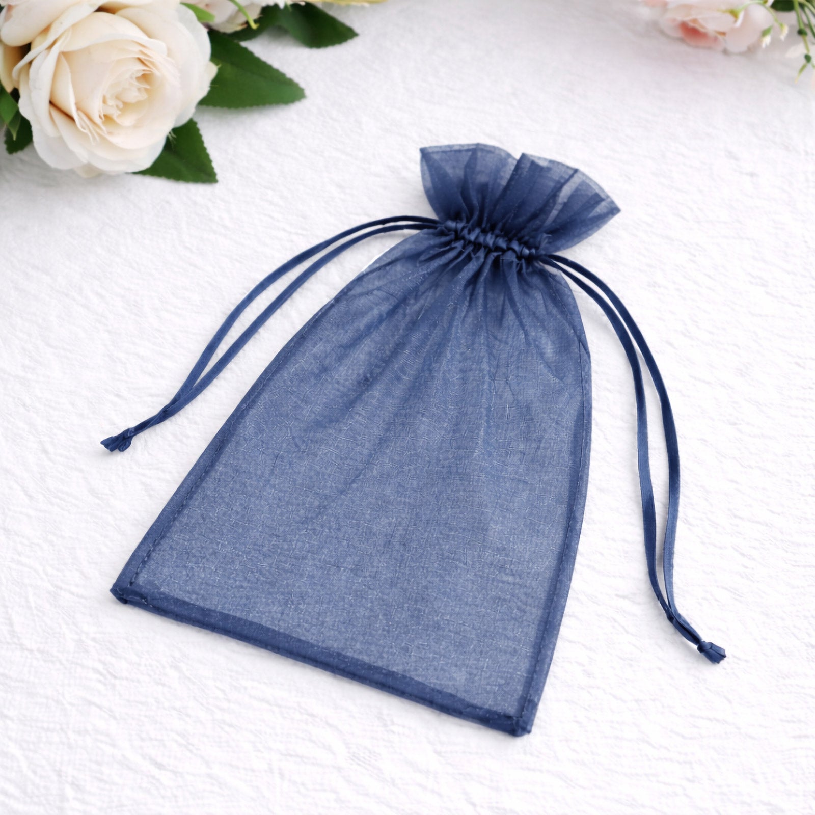 Navy blue organza gift bag with drawstring, perfect for wedding favors.