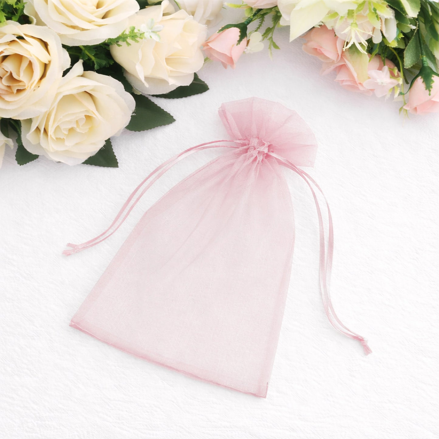 Pink organza gift bag with drawstring, 5" x 7", perfect for wedding favors.