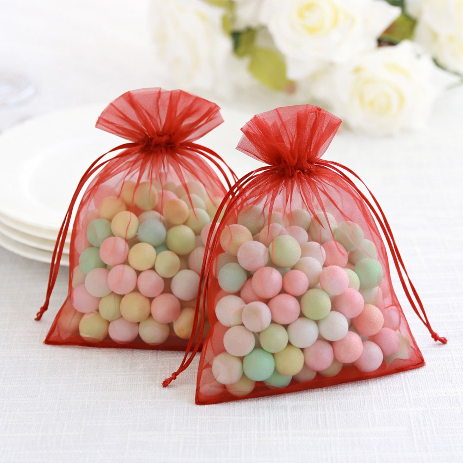 Red organza gift bags with drawstring, perfect for wedding favors.