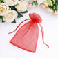 Red organza gift bag with drawstring, perfect for wedding favors.