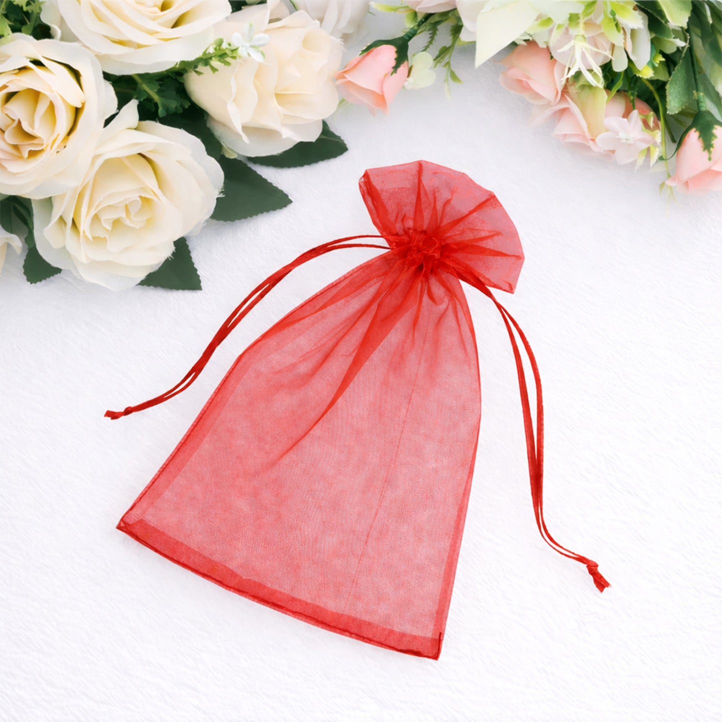 Red organza gift bag with drawstring, perfect for wedding favors.
