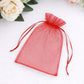Red organza gift bag with drawstring for wedding party favors.