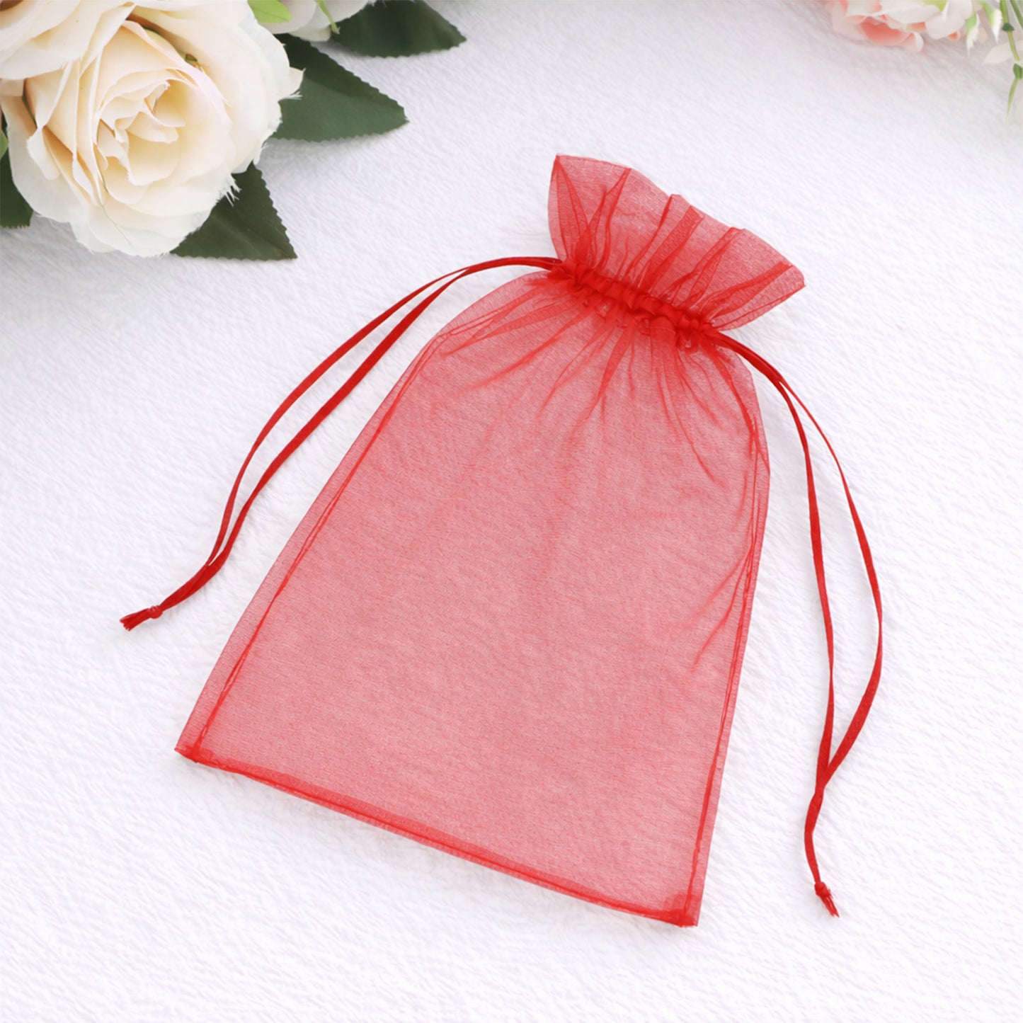 Red organza gift bag with drawstring for wedding party favors.