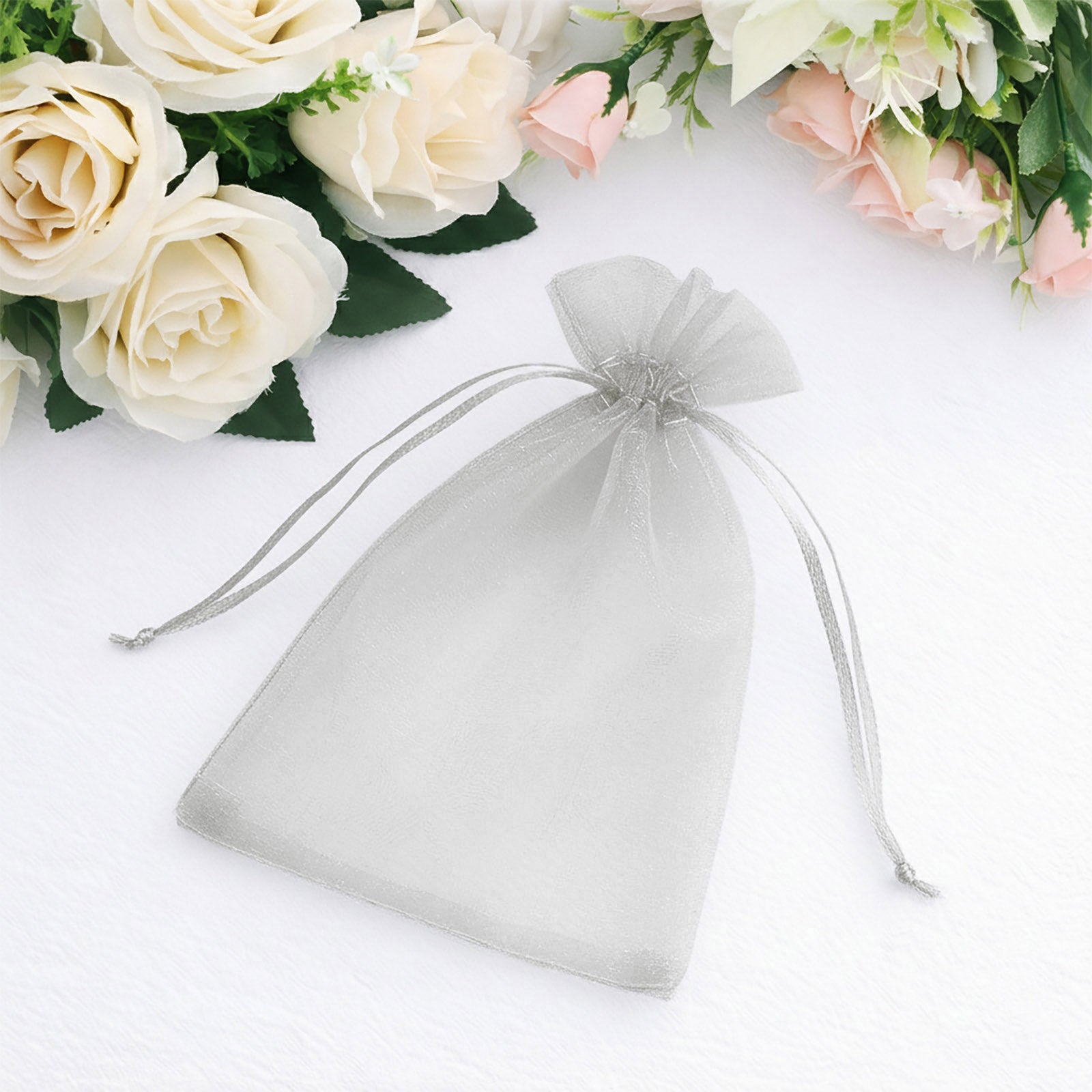 Silver organza gift bag with drawstring, 5" x 7", perfect for wedding favors.