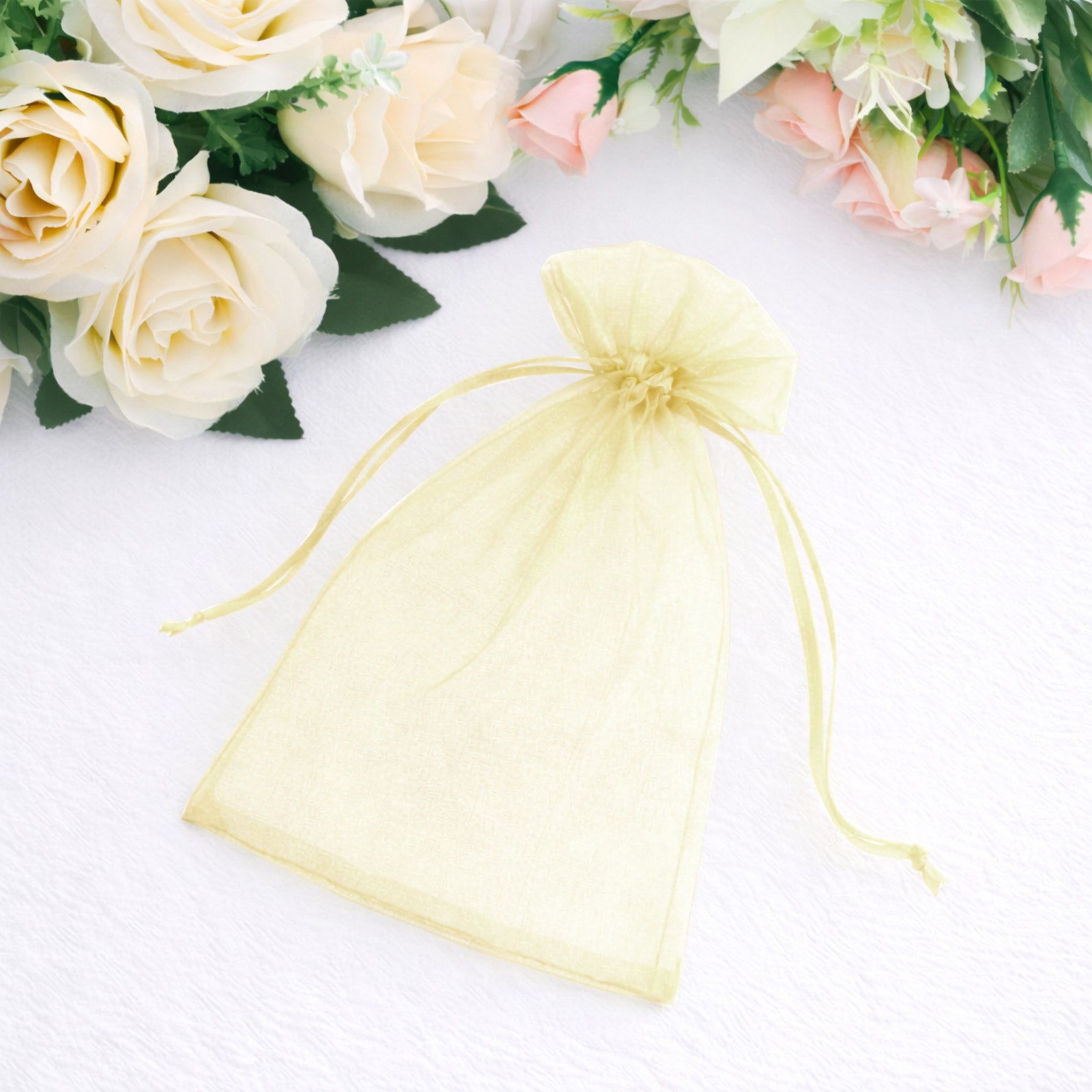 Yellow organza gift bag with drawstring, perfect for wedding favors.