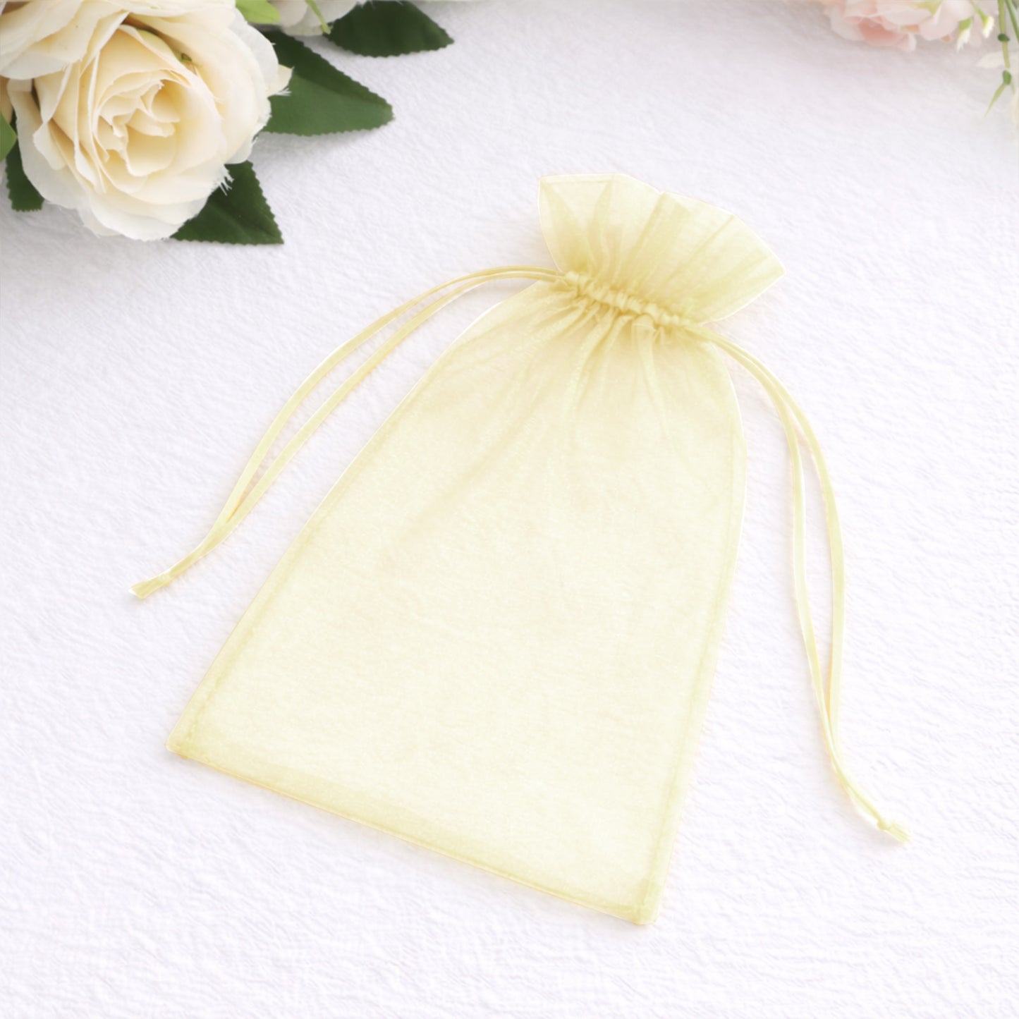 Yellow organza gift bag with drawstring, 5" x 7", perfect for wedding favors.