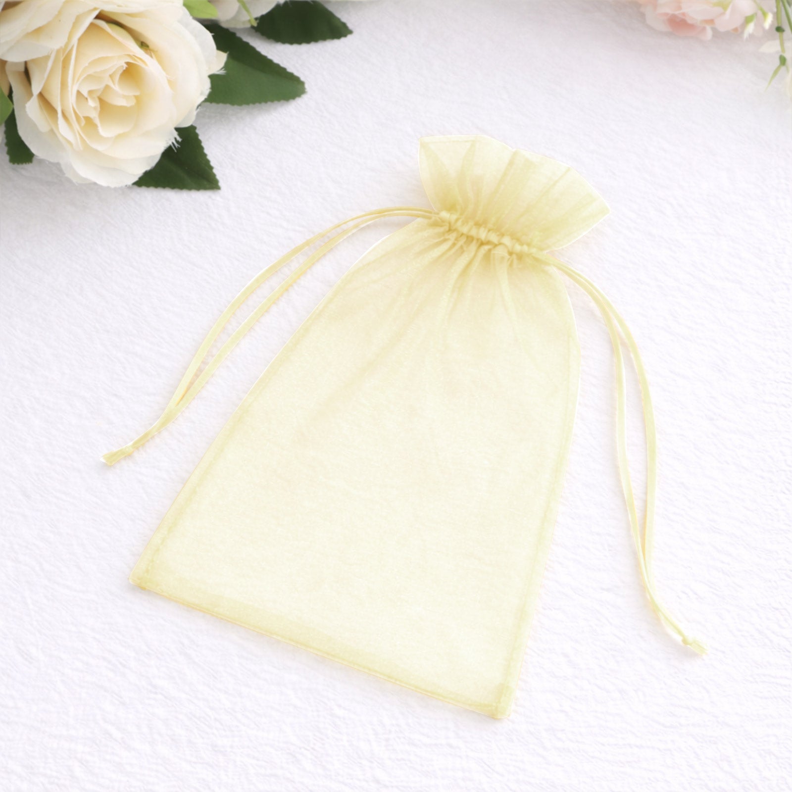 Yellow organza gift bag with drawstring, 5" x 7", perfect for wedding favors.