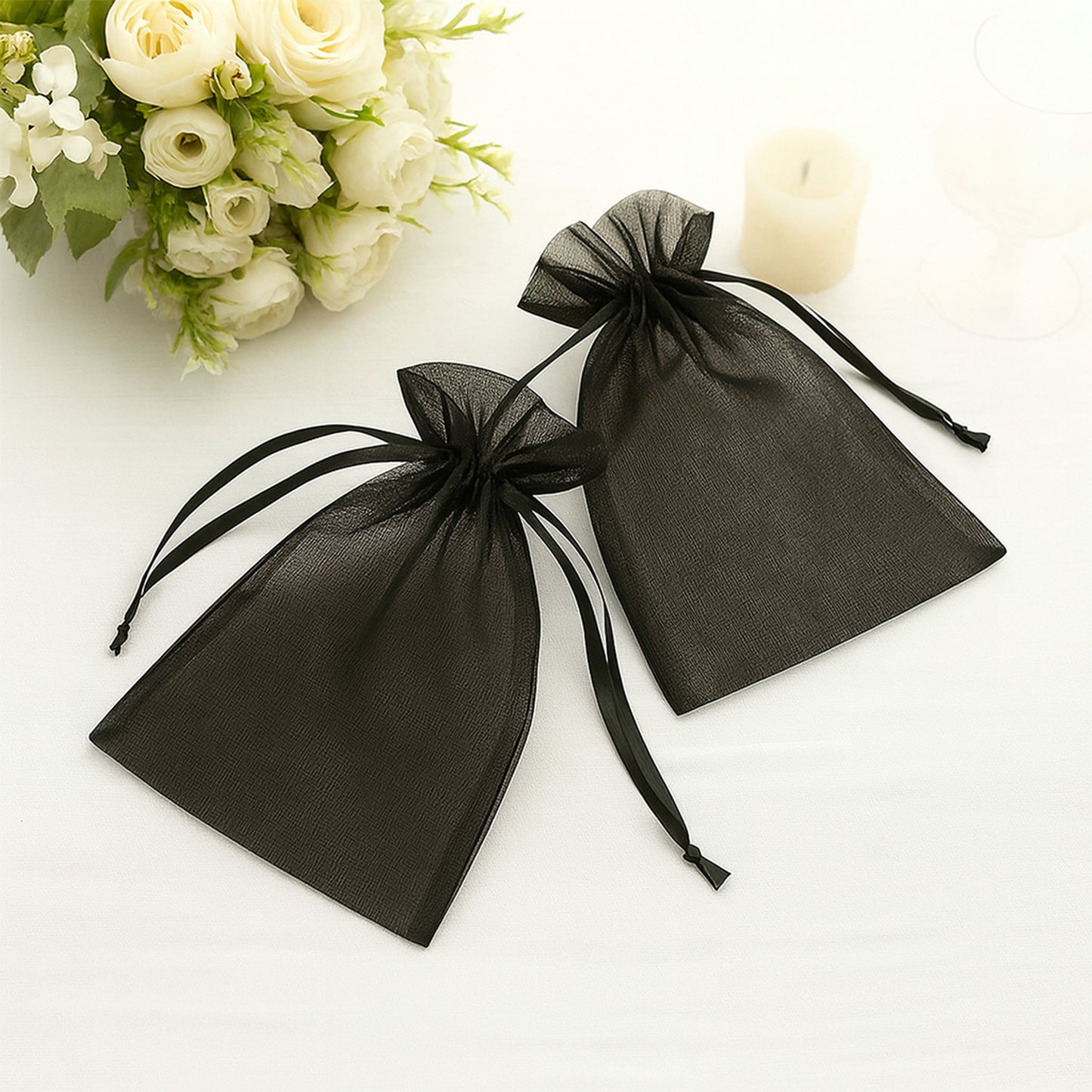 Black organza gift bags with drawstring, 6" x 9". Perfect for weddings and parties.