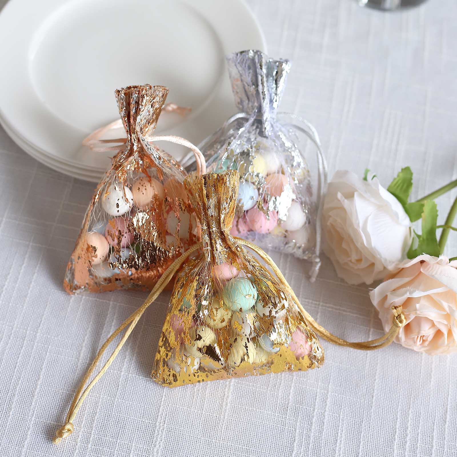 Metallic gold drawstring candy bag with pastel candies inside.